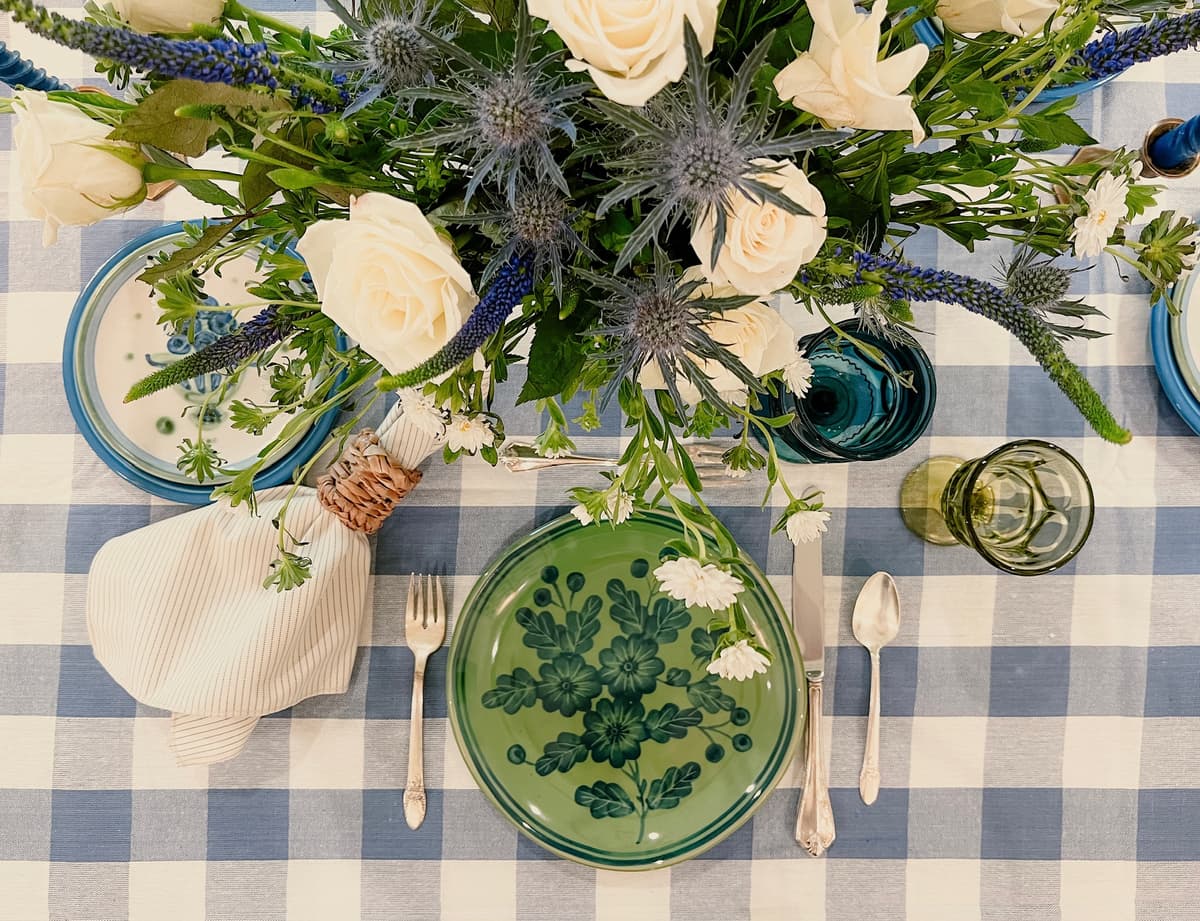 Beautiful table setting with vintage blueberry china, blue gingham tablecloth, and colorful glassware for intimate gathering in Bakersfield